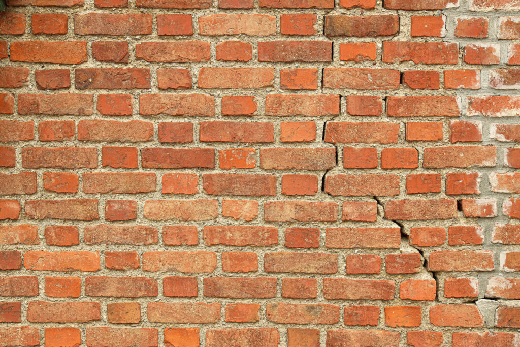 stair-step cracks in a brick wall